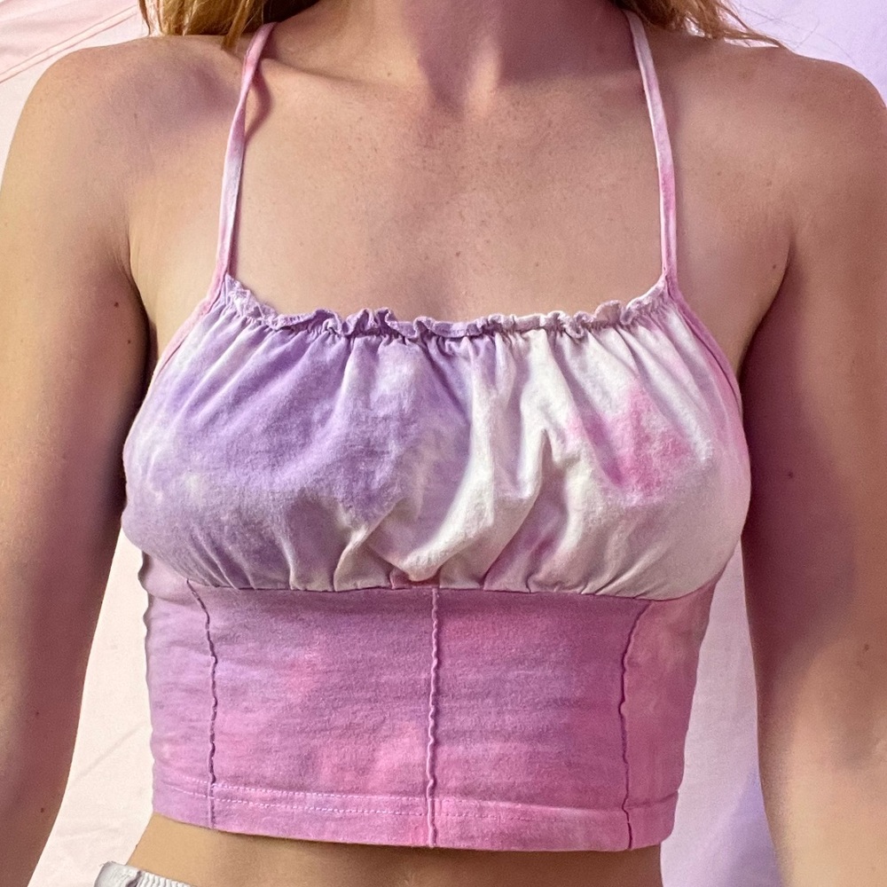 Tie dye tank top with ruffled neckline.